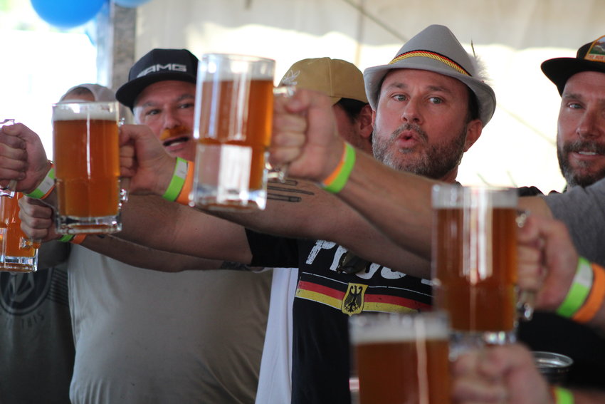 Donned in a gray German alpine hat, Mike Harding scopes out his opponents in the beer-stein-holding competition during the inaugural Wild West Oktoberfest Sept. 24 in downtown Golden.